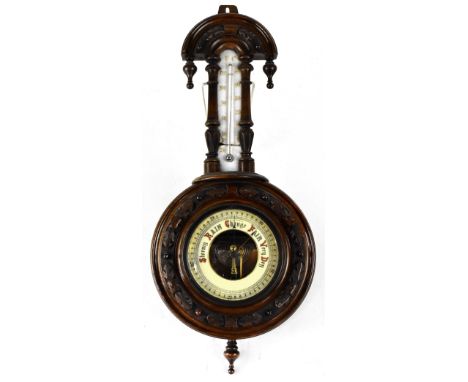 A Victorian walnut banjo barometer, the ivorine dial within a carved surround beneath a ceramic mercury thermometer, height 5