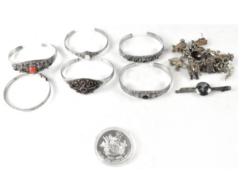 Various items of vintage silver jewellery to include a charm bracelet, an adjustable bracelet, five Middle Eastern style brac