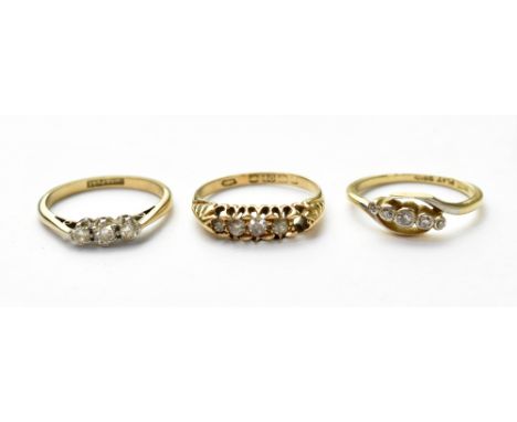 Three 18ct gold diamond rings, one set with three small diamonds, size J, one set with five stones (one missing) size L, the 