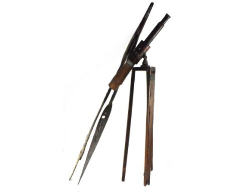 An early 20th century telescope with wooden barrel and leather-bound scope, on a vintage wood and metal tripod support, a pai