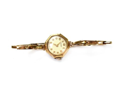 Rotary; a ladies' vintage 9ct gold wristwatch, raised gold numbers on a pale face, crown wound movement, on 9ct gold flexi st