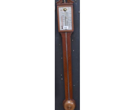 A reproduction mahogany-cased wall mounted stick barometer, silvered dial also contains a thermometer, length 95cm. CONDITION