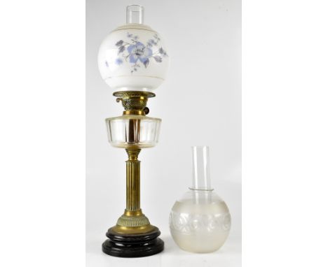 An Edwardian brass oil lamp, clear glass reserve to Classical column support to circular spreading base with floral painted o