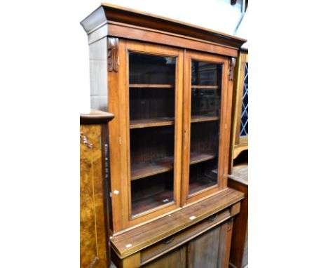 A 19th century mahogany break-front chiffonier bookcase, the top comprising a pair of glazed doors enclosing three adjustable