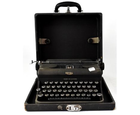 A boxed Royal Canadian mechanical typewriter in leatherette covered travelling case.