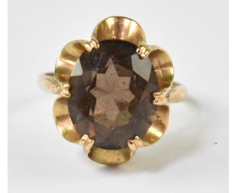 A 9ct yellow gold ladies' dress ring set with oval smoky quartz stone, size K, approx 3g.