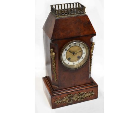 A Victorian burr walnut mantel clock with brass cast fittings, the ivorine dial set with Arabic numerals and enclosing a move