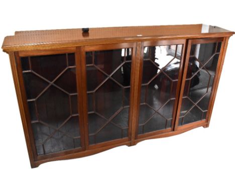 A reproduction Georgian-style mahogany bookcase, with four astragal glazed doors, raised on bracket feet, 106 x 190 x 37cm. C
