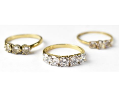 Two 9ct gold fashion rings each set with three cubic zirconia stones, sizes Q and R, approx 3.8g, also a silver gilt five sto