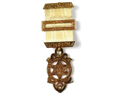 A 9ct gold Masonic medal with pierced star, square and compass within a circular border, with motto, stamped 375 on a gold ba