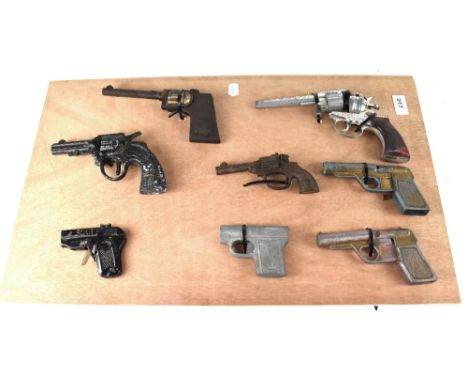A wooden display board showing eight vintage c1950s toy guns to include 'Lone Ranger', 'Star', 'Dandy', Fairylite' and four o