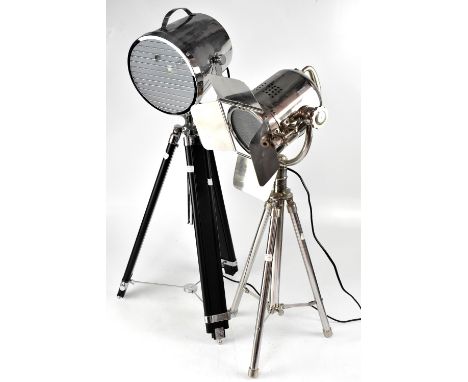 A contemporary floorstanding decorative light in the form of a director's light, white metal shade on a tripartite extending 