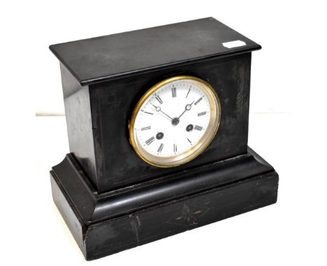 A Victorian slate mantel clock, the painted dial set with Roman numerals, enclosing a movement striking on a gong, with paper