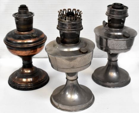 A Victorian brass oil lamp and two chrome oil lamps, height of largest 30cm (3).