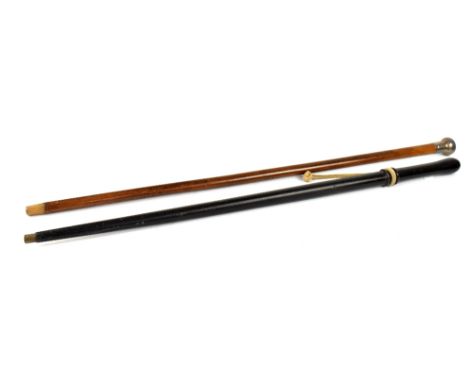 A 19th century wooden police truncheon with rope handle converted to a walking stick with brass end, length 87cm, and a walnu