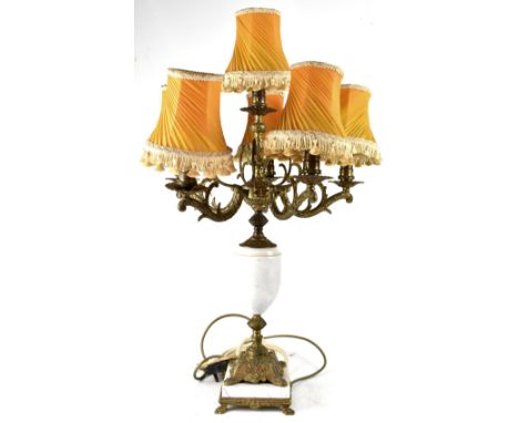 A French-style gilt metal and marble table lamp in the form of an urn, with four branches and gilt metal face, with four lion