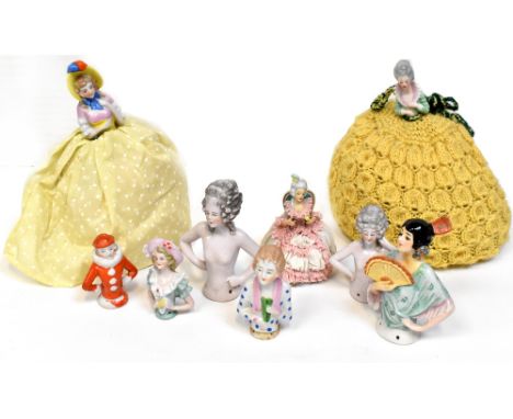 A quantity of 20th century ceramic half dolls, some with knitted skirts.
