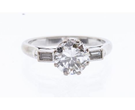 A diamond and 18ct white gold ring, comprising a central brilliant cut diamond claw set, weighing approx 1.83ct, assessed col