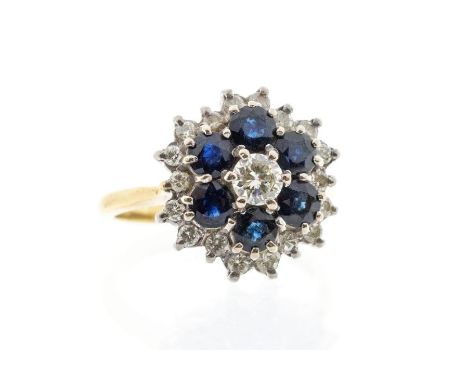 A sapphire and diamond 18ct gold cluster ring, the centre set with a round brilliant cut diamond approx 0.25ct, within a bord