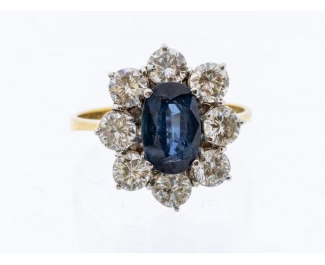 A sapphire and diamond cluster 18ct gold ring, comprising an oval sapphire set to the centre, approx 9 x 5 x 3.7mm, within a 