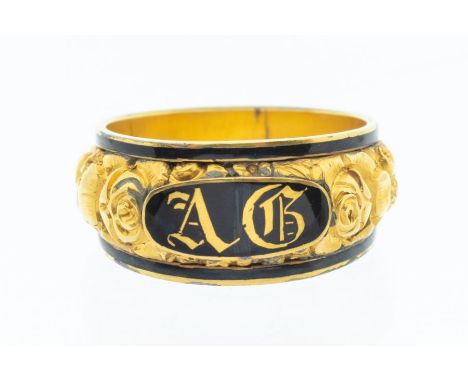 A George III 18ct gold and enamel mourning ring, with high relief floral decoration to the centre with applied black enamel p