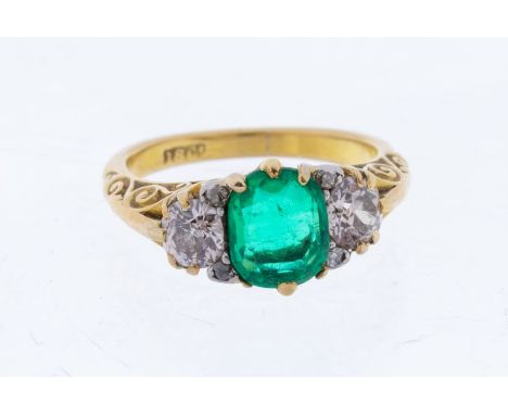 A Victorian emerald and diamond 18ct gold ring, comprising a central claw set cushion shaped emerald, approx 1carat, with old