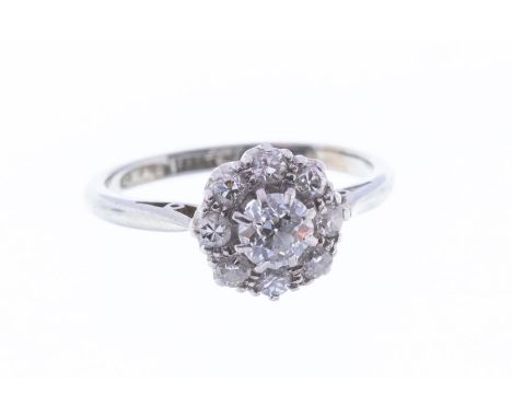 An early 20th century diamond and 18ct white gold cluster ring, comprising a central claw set old cut diamond approx 0.40ct, 