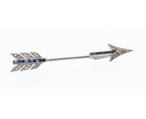 An Art Deco diamond and sapphire platinum jabot pin brooch, arrow form pave set with calibre cut sapphires to the shaft and f