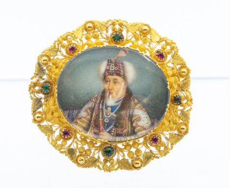 A 19th Century Indian Mughal yellow gold brooch, comprising an oval painted ivory miniature depicting a Mughal emperor, inset