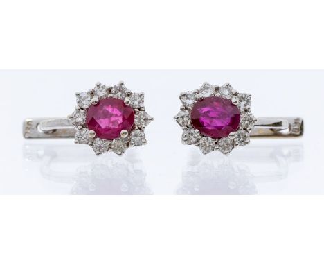 A pair of ruby and diamond 18ct white gold cluster earrings, comprising a central oval ruby, total gross weight approx 1.15ca