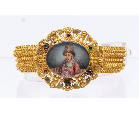 A 19th Century Indian Mughal bracelet, comprising an oval painted ivory miniature depicting a Mughal emperor, inset within a 