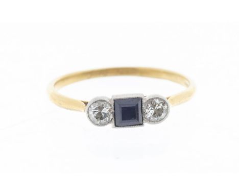 An Edwardian diamond and sapphire set 18ct gold ring, comprising a square cut sapphire to the centre, approx 3.5mm, with an o