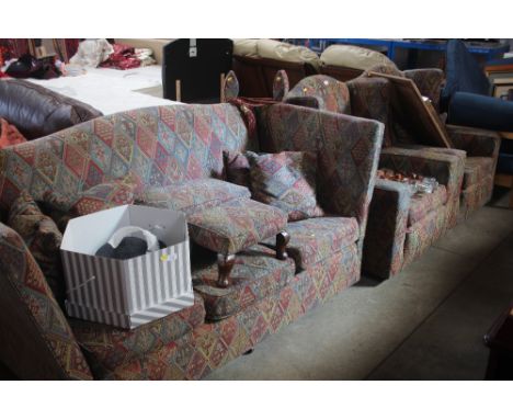 A Knoll style three seater settee with two matching wing back arm chairs