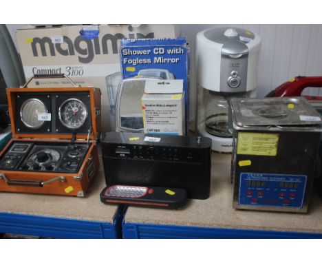 An LED torch; together with a Bush DAB radio; a shower CD with fog less mirror etc.