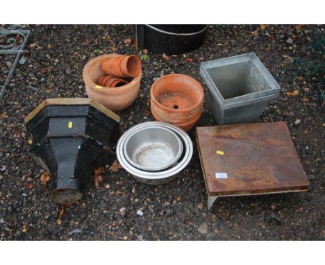 A cast iron rain hopper; dog bowls; terracotta planters etc