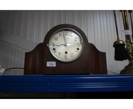 An oak cased three hole mantel clock