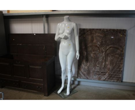 A female mannequin on stand 