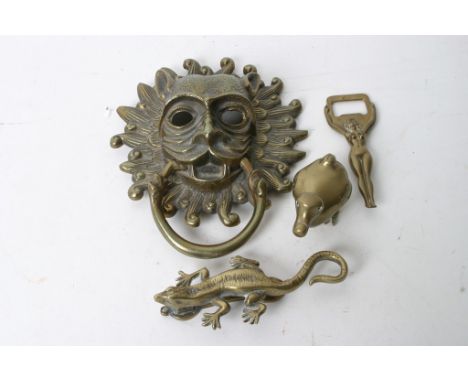 A brass lion door knocker, a smaller knocker shaped as a crocodile and other brass items