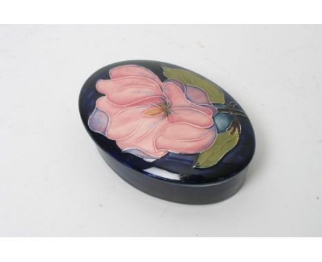 A further Moorcroft oval trinket box with blue ground floral decoration