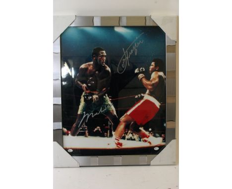 A framed Muhammad Ali v Joe Frasier boxing print, signed in silver by both boxers, framed in silver, the item measures 23" x 