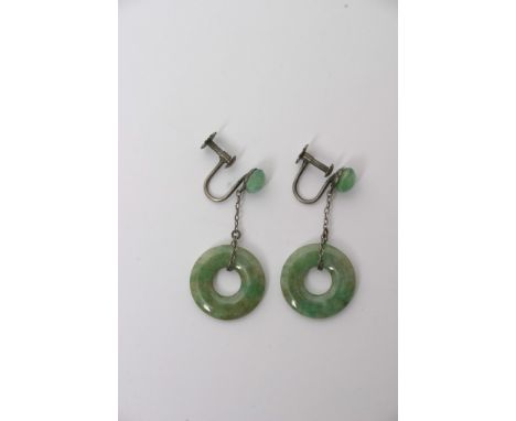 A pair of white metal earrings with attached Jade disc drops