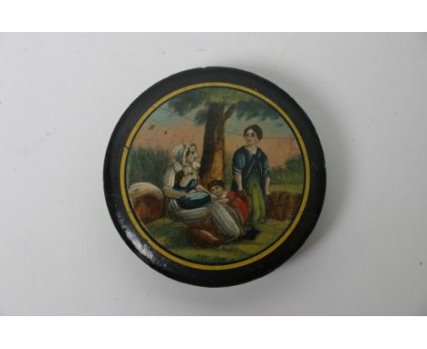 A circular snuff box with detachable lid decorated with figures