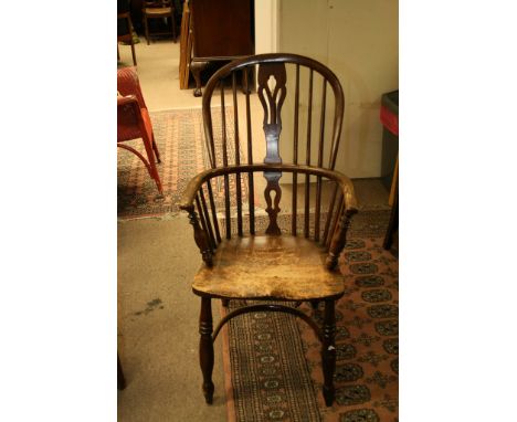 An early 19th century elm stick back chair the solid seat on turned legs 