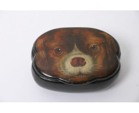 A small paper mache snuff box, the hinged lid decorated with the face of a dog