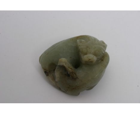 A Chinese jade carving of entwined mythical beasts