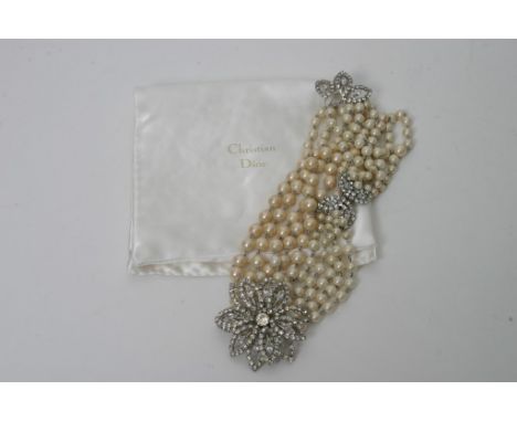 A boxed ladies costume jewellery necklace by Christian Dior formed from four rows of graduating simulated pearls with large p