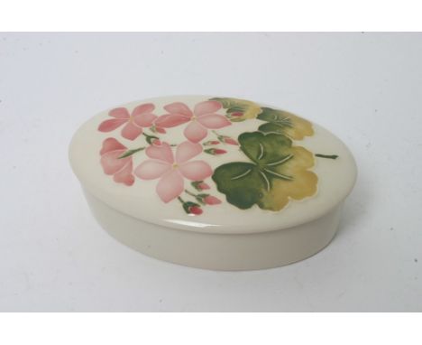 A Moorcroft oval trinket box with floral decoration