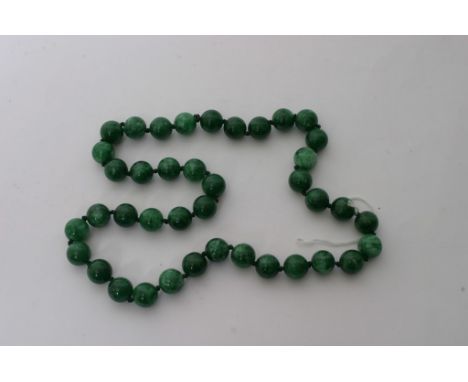 A Chinese green hardstone bead necklace possibly jade