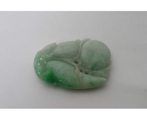 A Chinese jade pendant in the form of a double gourd with foliage surmounted by a small animal. Length: 58mm approximately