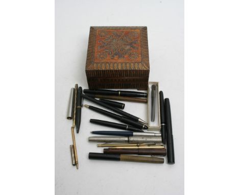A small collection of various pens and cufflinks